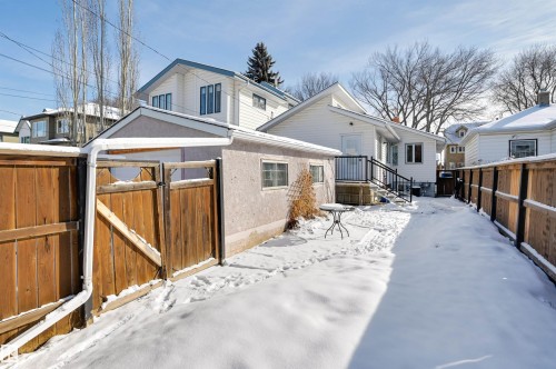 The property features a fenced yard with a detached garage and a separate entrance to the main residence - 11116 52 Street Nw, Edmonton, AB - Outdoor