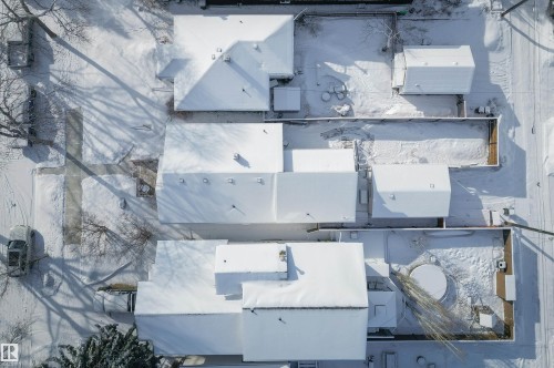Aerial view of the property and surrounding neighborhood, featuring snow-covered rooftops and grounds - 11116 52 Street Nw, Edmonton, AB - 