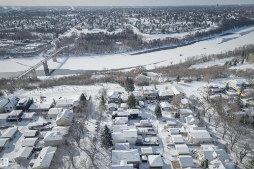 Aerial view of the neighborhood featuring a river, a bridge, and surrounding trees - 11116 52 Street Nw, Edmonton, AB - Outdoor With View