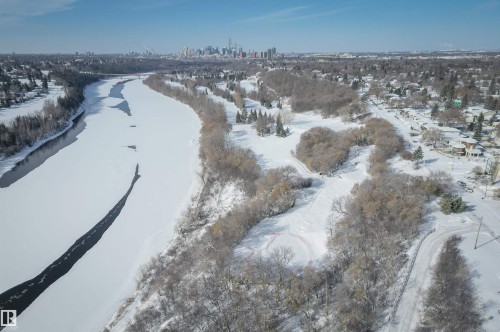 Aerial view showcasing a river with a partially frozen surface, surrounded by snow-covered land and bare trees - 11116 52 Street Nw, Edmonton, AB - Outdoor With View