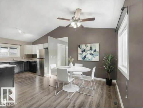 The kitchen and dining area feature durable flooring, a vaulted ceiling, and a ceiling fan with light fixture - 5035 51 Avenue, Lamont, AB - Indoor Photo Showing Other Room