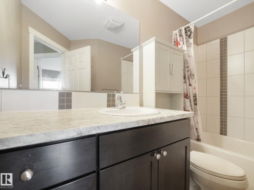 Bathroom featuring a vanity with a light-colored countertop, dark cabinetry, and a round sink basin - 5035 51 Avenue, Lamont, AB - Indoor Photo Showing Bathroom