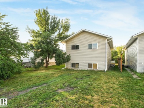 Exterior featuring light beige horizontal siding and white trim - 5035 51 Avenue, Lamont, AB - Outdoor