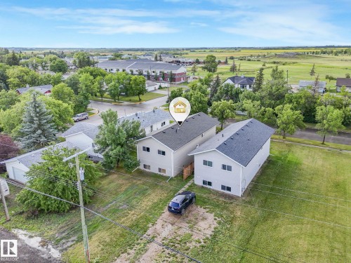Two-story duplex featuring light gray siding and dark shingle roofing - 5035 51 Avenue, Lamont, AB - Outdoor With View