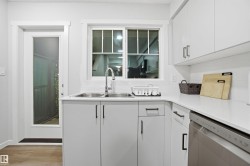 Kitchen featuring white cabinets, dishwasher, light wood-type flooring, and modern cabinets - 