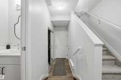 Stairs with a textured ceiling and wood finished floors - 