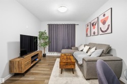 Living room featuring wood finished floors and a textured ceiling - 