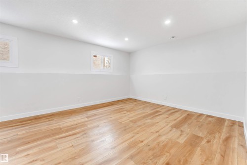 Room featuring light-toned flooring, recessed lighting, and two windows - 10865 21 Ave, Edmonton, AB - Indoor Photo Showing Other Room