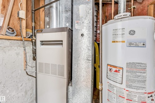 The property is equipped with a hot water heater and a furnace - 10865 21 Ave, Edmonton, AB - Indoor Photo Showing Basement