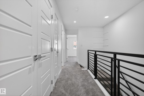 Hallway with gray carpet flooring and recessed lighting - 408 Crystal Creek Link, Leduc, AB - Indoor Photo Showing Other Room