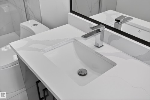 Vanity featuring an integrated rectangular sink and a chrome single-handle faucet - 408 Crystal Creek Link, Leduc, AB - Indoor