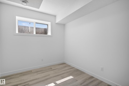 Bright room with wood-finish flooring, crisp white walls, and a recessed window - 408 Crystal Creek Link, Leduc, AB - Indoor Photo Showing Other Room