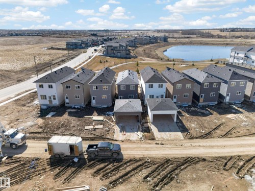 New construction residences featuring multi-story designs with dark shingle roofs and light-toned siding - 408 Crystal Creek Link, Leduc, AB - Outdoor With View