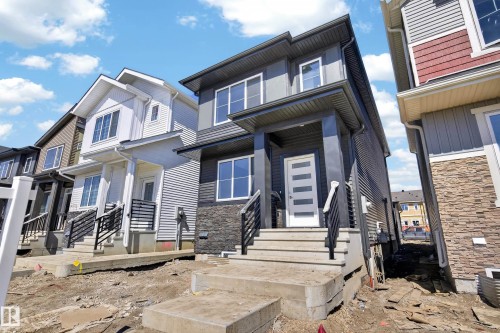 Contemporary two-story exterior with dark gray siding - 408 Crystal Creek Link, Leduc, AB - Outdoor With Facade
