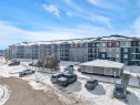 The property features a multi-story building with a contemporary exterior design, including balconies and varying facade textures - 415 12035 22 Avenue, Edmonton, AB  - Outdoor With Balcony 