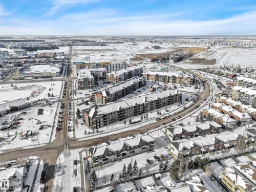 The property is situated within a vibrant community featuring various residential buildings and roads - 415 12035 22 Avenue, Edmonton, AB - Outdoor With View