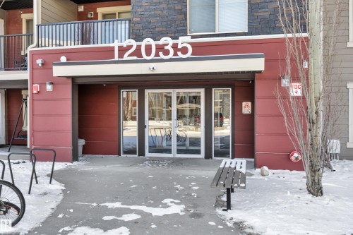 The property features a primary entrance with glass doors, a covered entryway, and a bench - 415 12035 22 Avenue, Edmonton, AB - Outdoor With Balcony