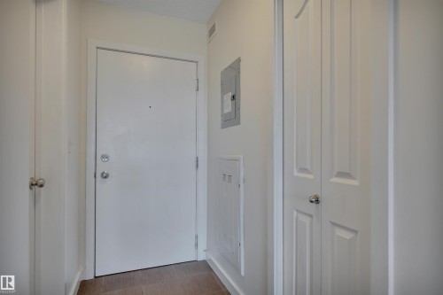 Entryway with wood flooring, a white door, and white walls - 415 12035 22 Avenue, Edmonton, AB - Indoor Photo Showing Other Room