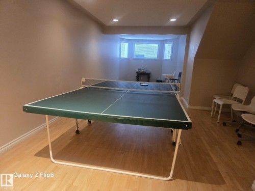 This spacious area features light wood flooring and recessed lighting - Edmonton, AB - Indoor Photo Showing Other Room