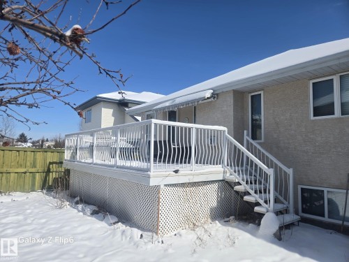 The property features an exterior deck with white railings and stairs, providing direct access to the yard - Edmonton, AB - Outdoor With Deck Patio Veranda With Exterior