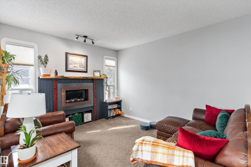 9 4403 Riverbend Road, Edmonton, AB - Indoor Photo Showing Living Room With Fireplace