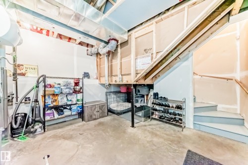 The basement features a concrete floor, exposed ductwork, and partially finished walls - 86 4029 Orchards Drive, Edmonton, AB - Indoor