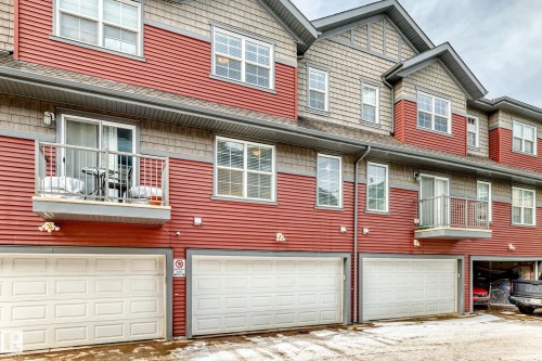 The property features a multi-level design with red siding and gray shingle accents - 86 4029 Orchards Drive, Edmonton, AB - Outdoor With Exterior