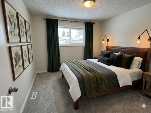 The room features light gray carpeting, neutral-toned walls, and a window - 13323 68 Street, Edmonton, AB - Indoor Photo Showing Bedroom