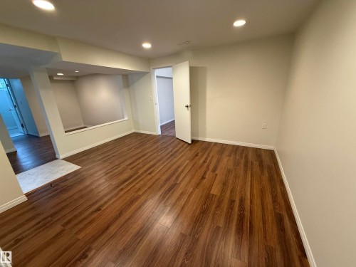 Spacious room featuring wood flooring and recessed lighting - 13323 68 Street, Edmonton, AB - Indoor Photo Showing Other Room