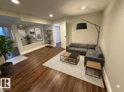 This inviting living area features warm-toned flooring and recessed lighting, creating a bright and welcoming atmosphere - 13323 68 Street, Edmonton, AB - Indoor Photo Showing Other Room