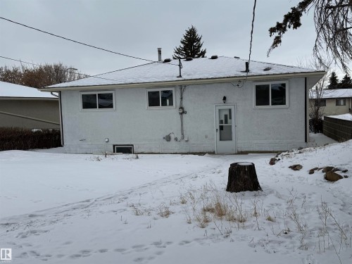 The property features a white exterior with white window frames and a white back door - 13323 68 Street, Edmonton, AB - Outdoor