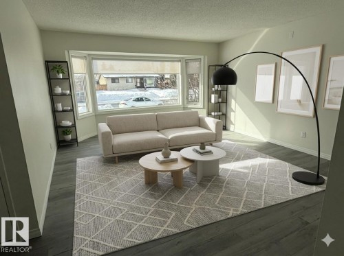 This living area features a bay window, dark flooring, and light-colored walls - 13323 68 Street, Edmonton, AB - Indoor