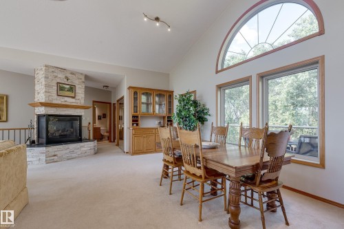 602 Pheasant Close, Rural Camrose County, AB - Indoor Photo Showing Dining Room With Fireplace
