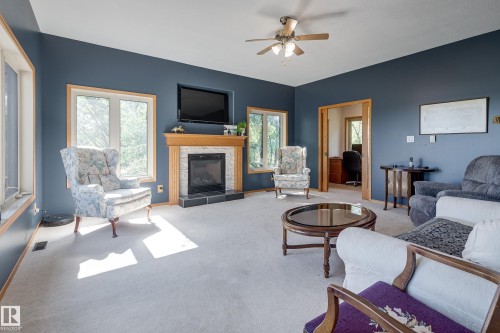 Family room which could be used for guest room - 602 Pheasant Close, Rural Camrose County, AB - Indoor Photo Showing Living Room With Fireplace