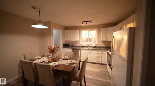 Dining area with a textured ceiling and light wood-type flooring - 2311 146 Avenue, Edmonton, AB - Indoor Photo Showing Other Room