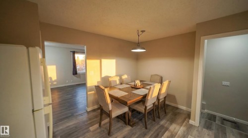 Dining area featuring dark wood finished floors and a textured ceiling - 2311 146 Avenue, Edmonton, AB - Indoor Photo Showing Dining Room
