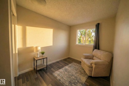 Sitting room with a textured ceiling, vaulted ceiling, and dark wood-style floors - 2311 146 Avenue, Edmonton, AB - Indoor Photo Showing Other Room