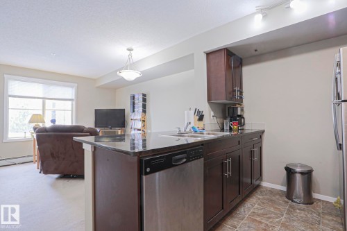 110 3207 James Mowatt Trail, Edmonton, AB - Indoor Photo Showing Kitchen With Double Sink