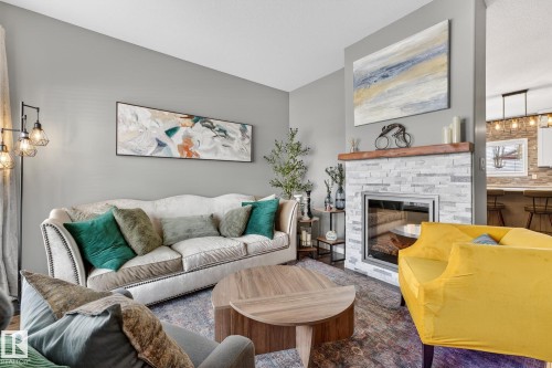 11 4367 Veterans Way, Edmonton, AB - Indoor Photo Showing Living Room With Fireplace