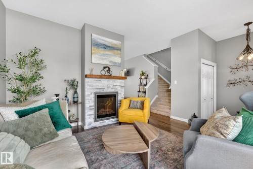 11 4367 Veterans Way, Edmonton, AB - Indoor Photo Showing Living Room With Fireplace