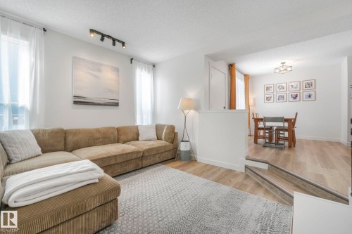 The property features an inviting living area with light-toned flooring and white walls, offering a bright and airy atmosphere - 33 4403 Riverbend Road, Edmonton, AB - Indoor Photo Showing Living Room