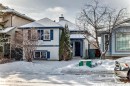 The property features a charming exterior with light-colored siding and contrasting blue shutters, set against a snow-covered landscape - 1911 36 Avenue, Edmonton, AB  - Outdoor 