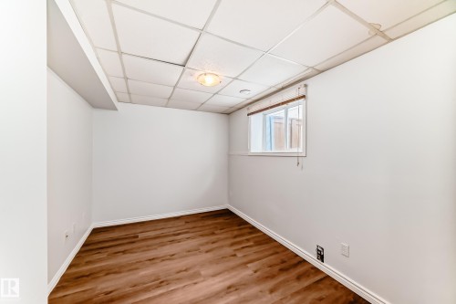 This room features light wood-look flooring and a window with blinds - 1911 36 Avenue, Edmonton, AB - Indoor Photo Showing Other Room