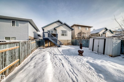 The property features an exterior deck with stairs and a spacious yard with a storage shed - 1911 36 Avenue, Edmonton, AB - Outdoor With Exterior