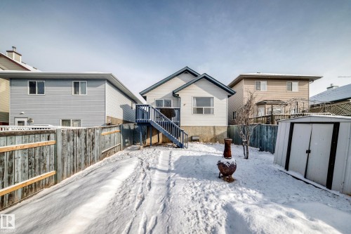 The property features a fenced yard, a rear deck with stairs, and a storage shed - 1911 36 Avenue, Edmonton, AB - Outdoor With Exterior