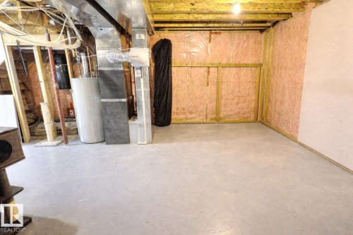 The property offers an unfinished basement with exposed wooden beams, insulation, and a concrete floor - 14 6608 158 Avenue, Edmonton, AB - Indoor Photo Showing Basement