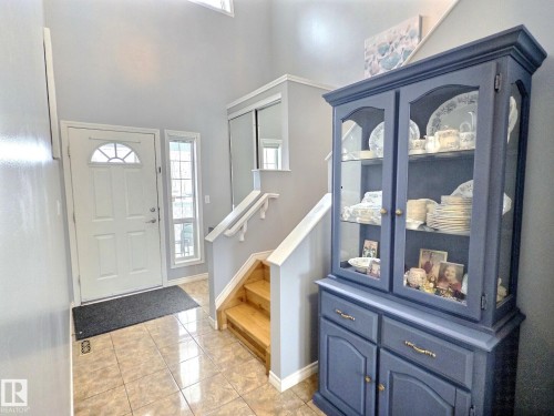 Entryway featuring tiled flooring, a front door with an arched window, and a window providing natural light - 14 6608 158 Avenue, Edmonton, AB - Indoor Photo Showing Other Room