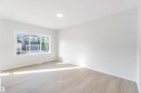 Bright interior space featuring light-toned flooring, white walls, and a large window providing natural light - 18940 28 Avenue, Edmonton, AB  - Indoor Photo Showing Other Room 