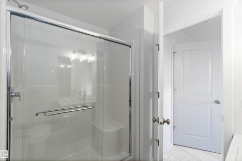 Bathroom featuring a clear glass shower enclosure with chrome hardware and a white interior - 5452 Hawthorn Run, Edmonton, AB - Indoor Photo Showing Bathroom