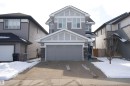The property features a two-story exterior with grey siding and white trim, complemented by a two-car garage with an overhead door - 20503 99 Avenue, Edmonton, AB  - Outdoor With Facade 